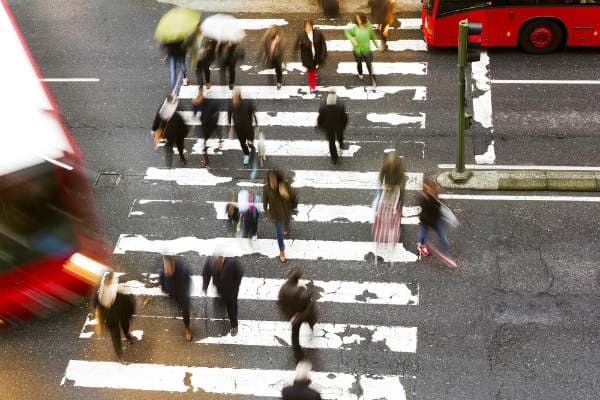 Crosswalk accident. Pedestrian with smartphone and headphones