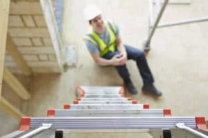 A man holds his injured knee after a premises liability accident in Richmond.