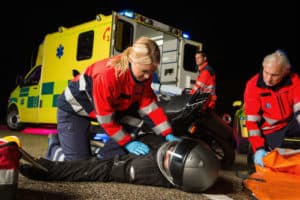 Paramedics attending to a motorcycle accident victim on a road in Virginia. 