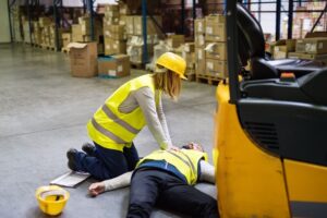 Coworker helping her teammate injured in warehouse.