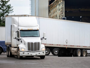 Big white truck making a left turn.