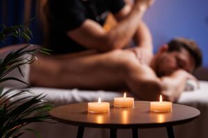 Masseuse gives therapeutic back massage to a visitor.