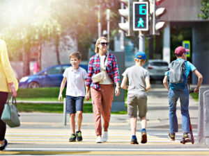 Mother and child crossing the street on pedestrian lane.