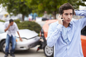 Problematic teen driver calling his parents to report accident.