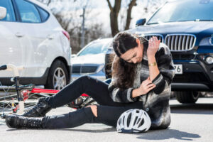 Injured lady biker at the middle of the street