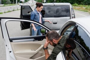 Drivers in the car accident checking the damages for claims.